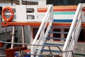 Colorful wooden boat deck with life buoy. Happy ship cruise background Royalty Free Stock Photo