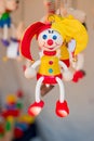 Colorful wooden buffoon figure hanging on the spring