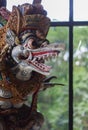 Colorful wooden carved statue of a deity in Indonesia