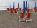 Colorful wooden chairs at sand beach . Tuscany, Italy