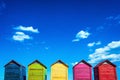 Colorful wooden changing huts on a beach, with nice background of clear blue sky on the coast