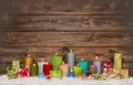 Colorful wooden christmas background with candles and presents. Royalty Free Stock Photo