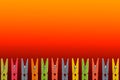 Colorful wooden clothespins on Red background Royalty Free Stock Photo