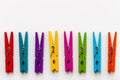 Colorful wooden clothespins on white background with copy space/diversity concept Royalty Free Stock Photo