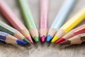 Colorful wooden color pencils on rustic background