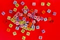 Colorful wooden cube beads with letters on red festive background word \