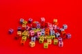 Colorful wooden cube beads with letters on red festive background word \