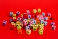 Colorful wooden cube beads with letters on red festive background word \