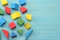 colorful wooden cubes on blue wooden background. Top view. Toys in the table