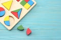 Colorful wooden cubes on blue wooden background. Top view. Toys in the table