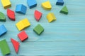 colorful wooden cubes on blue wooden background. Top view. Toys in the table