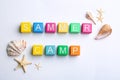 Colorful wooden cubes with phrase SUMMER CAMP on white background, flat lay Royalty Free Stock Photo