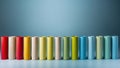 Colorful Wooden Cylinders in a Row on Blue Background. Royalty Free Stock Photo
