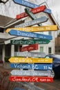 Colorful direction arrow signs on wooden pole. Direction to different places of the world indicated in a street sign Royalty Free Stock Photo