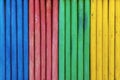 Colorful wooden fence painted in blue, red, green and yellow colorsÃÅ½ Royalty Free Stock Photo