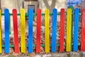 Colorful wooden fence painted in blue, yellow and red Royalty Free Stock Photo