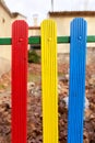 Colorful wooden fence painted in blue, yellow and red Royalty Free Stock Photo