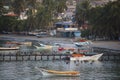 Colorful wooden fisher boats anchored in the bay of Pampatar wit