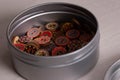 Multicolored wooden flower sewing buttons in a metal container macro shot. Royalty Free Stock Photo