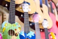 colorful wooden guitars hanging on wall of store showroom