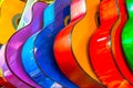 colorful wooden guitars hanging on wall of store showroom Royalty Free Stock Photo