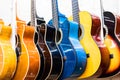 colorful wooden guitars hanging on wall of store showroom Royalty Free Stock Photo