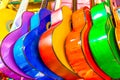 colorful wooden guitars hanging on wall of store showroom Royalty Free Stock Photo