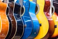 colorful wooden guitars hanging on wall of store showroom Royalty Free Stock Photo