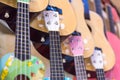 colorful wooden guitars hanging on wall of store showroom