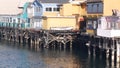 Colorful wooden houses on piles or pillars, Old Fisherman's Wharf, Monterey bay.