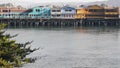 Colorful wooden houses on piles or pillars, Old Fisherman's Wharf, Monterey bay.