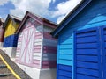 Colorful wooden houses in a row in a public park. Colorful beach huts Royalty Free Stock Photo