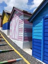 Colorful wooden houses in a row in a public park. Colorful beach huts Royalty Free Stock Photo