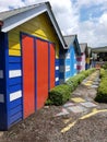 Colorful wooden houses in a row in a public park. Colorful beach huts Royalty Free Stock Photo