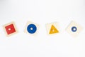 Wooden Montessori sensorial material learning educational toys on white background. Geometric shape sorting board toys Royalty Free Stock Photo