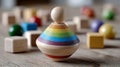 Colorful wooden spinning top with blocks on a wooden surface. Royalty Free Stock Photo