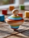 Colorful wooden spinning top on rustic wooden surface. Royalty Free Stock Photo