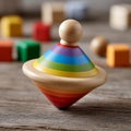 Colorful wooden spinning top surrounded by blurred blocks. Royalty Free Stock Photo