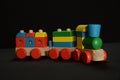 Colorful wooden train toy on the black background Royalty Free Stock Photo