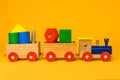 A colorful wooden train toy for children with orange background Royalty Free Stock Photo