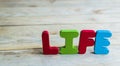 Colorful wooden word Life on wooden floor2