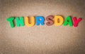 Colorful wooden word THURSDAY on Cork board with selective focus