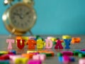 Colorful wooden word TUESDAY on wooden table and vintage alarm clock and background is powder blue. English alphabet made of woode