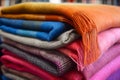 Colorful wool or alpaca blankets stacked in pile. Generative AI Royalty Free Stock Photo