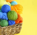 Colorful woolen balls of yarn. Balls of yarn are in the basket. Needlework. Royalty Free Stock Photo