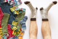 Colorful woolen socks and a pair of legs on white background Royalty Free Stock Photo