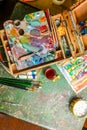 Colorful workplace of the artist with oil paints - vertical