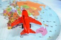 Colorful world map with airplane on it with the continents Africa, Europe, North America, Asia, South America, Australia and