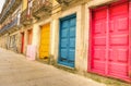 Colorful worn painted doors along street in Porto - Artistic portuguese city concept - Warm filtered look