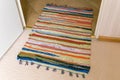 Colorful woven doorway rug on carpet and tile transition Royalty Free Stock Photo